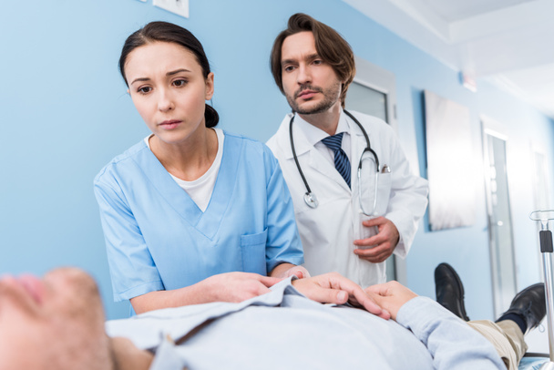 Worried doctors with stethoscope looking at patient - Photo, Image