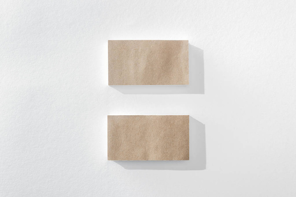 top view of empty brown cards on white background with copy space - Foto, afbeelding