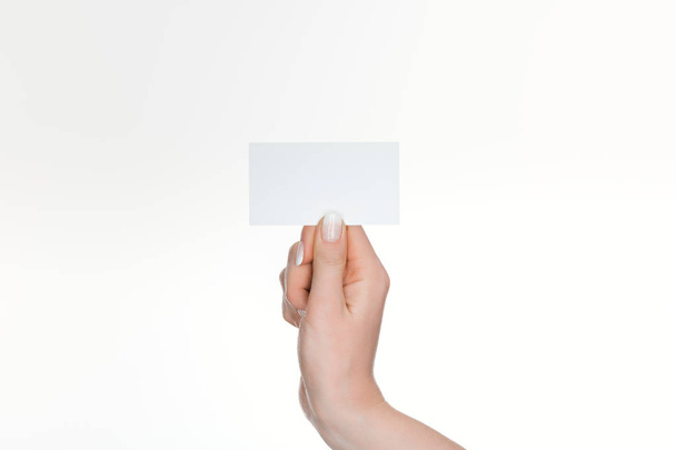partial view of woman holding blank and empty card isolated on white - Zdjęcie, obraz