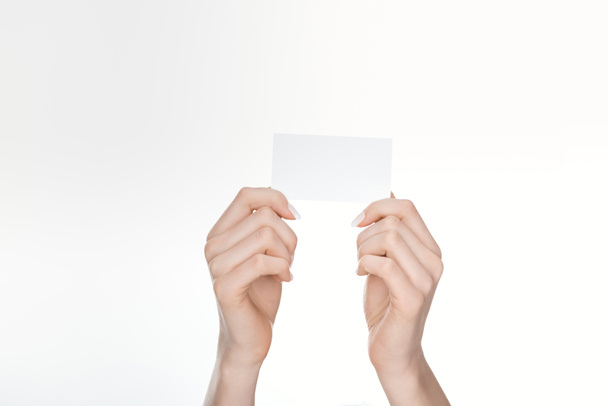 cropped view of woman holding blank card isolated on white - Фото, изображение