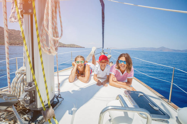 Family with adorable kids resting on yacht - Foto, Bild