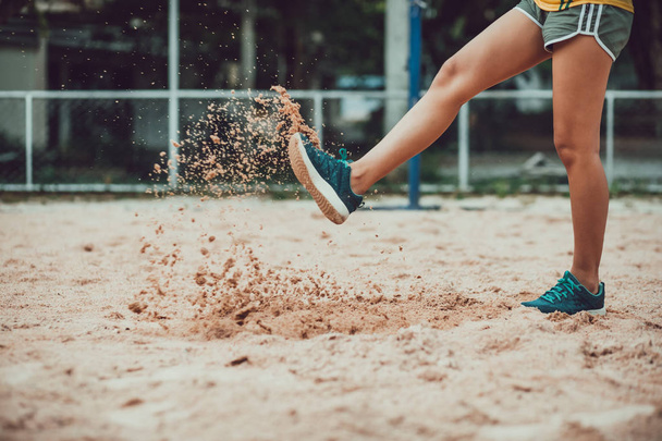 leg sport women kick sand because fail competition. - Фото, изображение