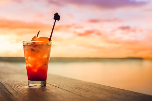 Mocktail on the table near swimming pool and sunset cloud. - Zdjęcie, obraz