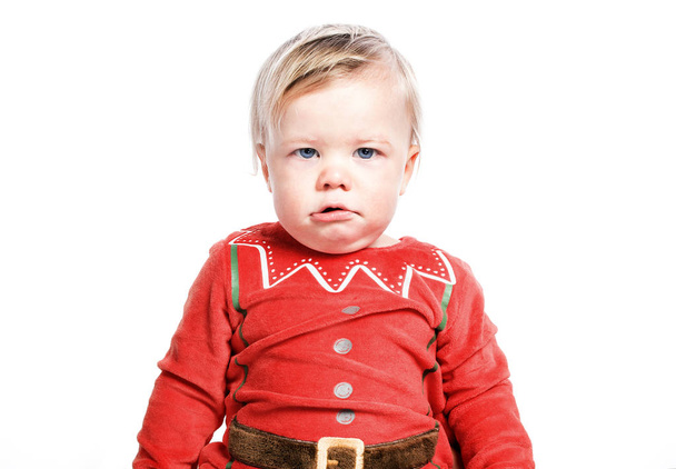 Sad kid dressed as Santa Claus. Christmas boy. One isolated on white background - Photo, Image