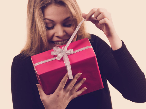 People celebrating xmas love and happiness concept - beauty girl opening present pink gift box. - Foto, Imagem