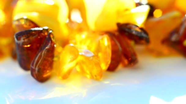 Amber necklace on turn table in sunny lighting - Footage, Video