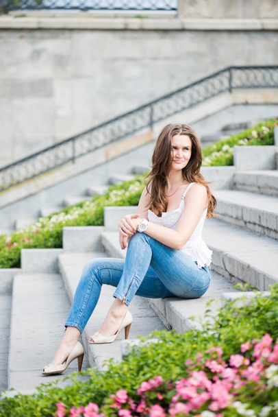 Portrait of a beautiful european woman sitting om steps - Foto, Imagem