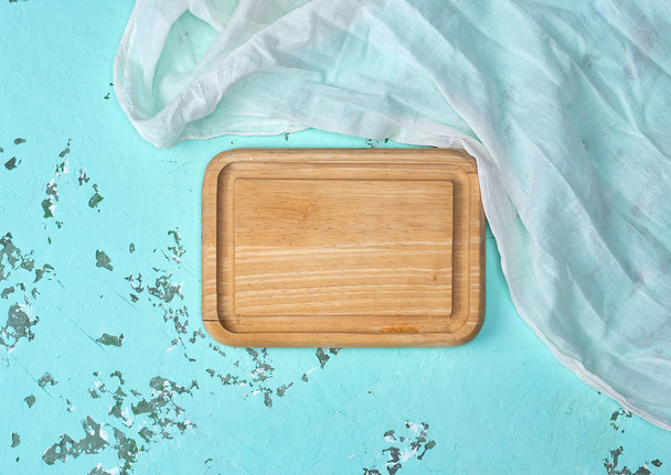 empty wooden cutting board on green background, top view - Photo, Image