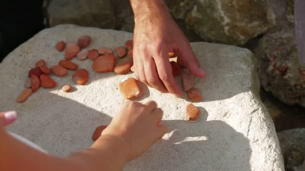 Forming a heart with mosaic of small stones. Mosaic heart. - Footage, Video