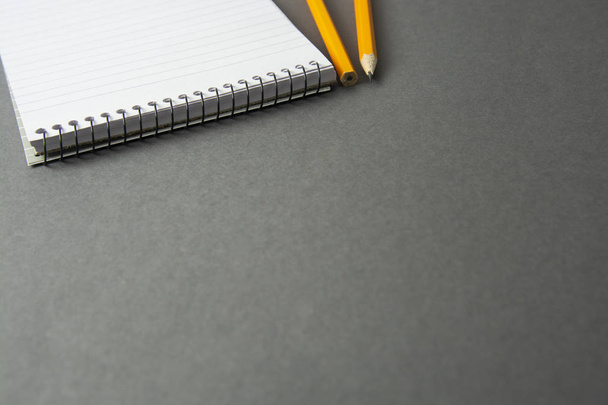 Notepad or notebook with pencil on gray background. Concept for education, business - Foto, immagini