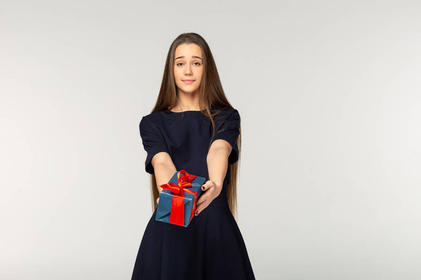 Beautiful young girl gives or receives a gift - Photo, Image