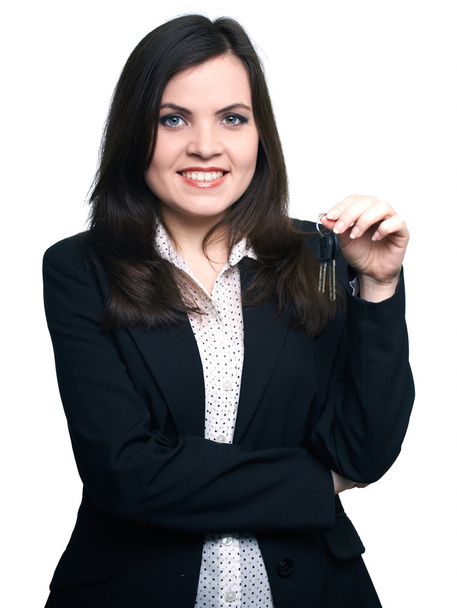 Attractive young woman in a black jacket. Woman holds the keys. - Photo, Image