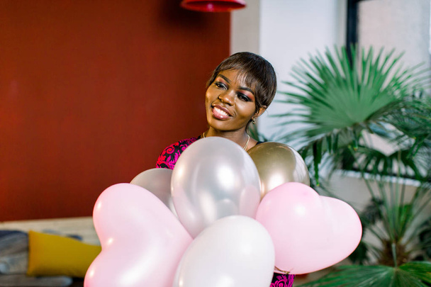 Happy young african woman in dress with balloons in her hands. - Photo, Image