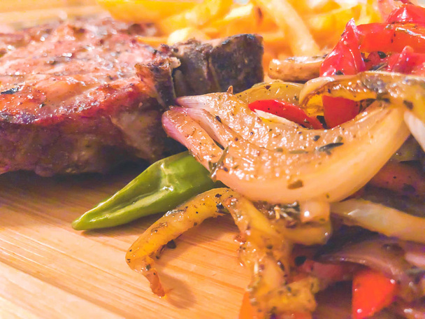 Brisket with french fries, vegetables and ketchup on a wooden tray - Foto, Imagem