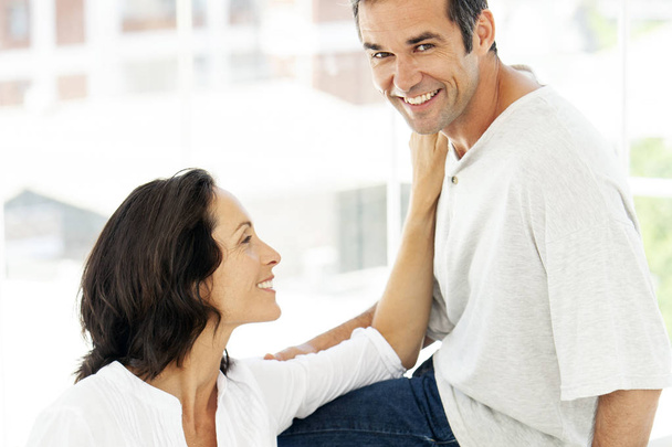 couple in love - moment of intimacy between middle aged man and woman - man looking at camera - Photo, Image