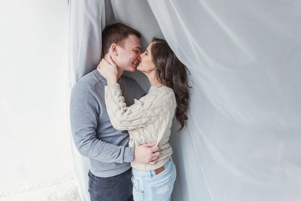 Romantic sexy couple in love having nice time together. Young woman hugging boyfriend, white background. Students, bride, groom, engagement, relationship, aspirations, supporting relying concept - Photo, Image