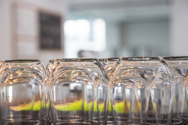 Empty Upside Down Glasses in a Quiet Calm Cafe Warm Light Gastronomy Equipment - 写真・画像