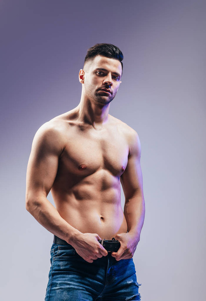 Portrait of a sexy muscular shirtless man posing in studio - Zdjęcie, obraz