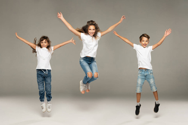 Happy jumping young friends - 写真・画像