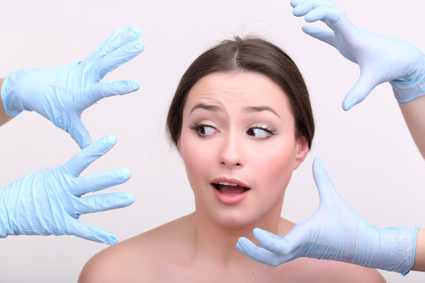 Rubber gloves touching face of  woman - Фото, зображення