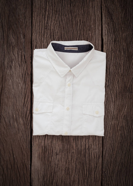White Shirt on wooden background - Foto, afbeelding