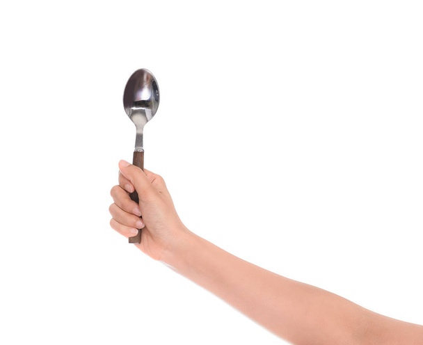 Woman hand holding an empty spoon, composition isolated over on the white background with clipping path - Valokuva, kuva