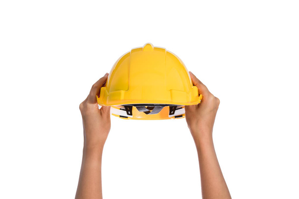 Woman two hand holding a hardhat, helmet isolated on white background - Foto, immagini