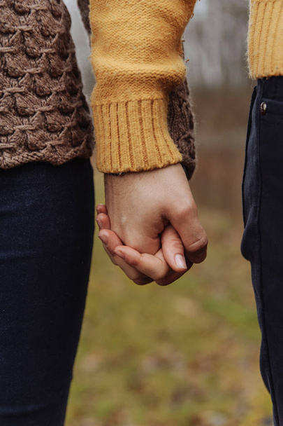 Young man and woman holding hands - Photo, Image