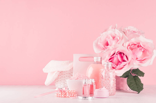 Elegant pink skin and body care products - cream, rose oil, liquid soap, salt, cotton towel and box - cosmetic accessories, romantic flowers on white wood table, copy space. - Fotografie, Obrázek
