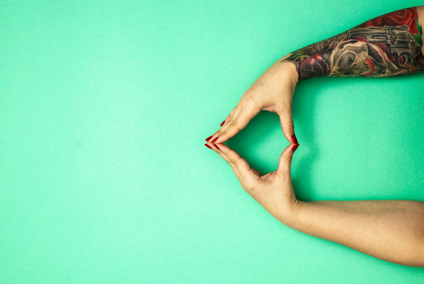 tattooed hands of a girl on green casino background with copy space ,  flat lay , top view - Photo, Image