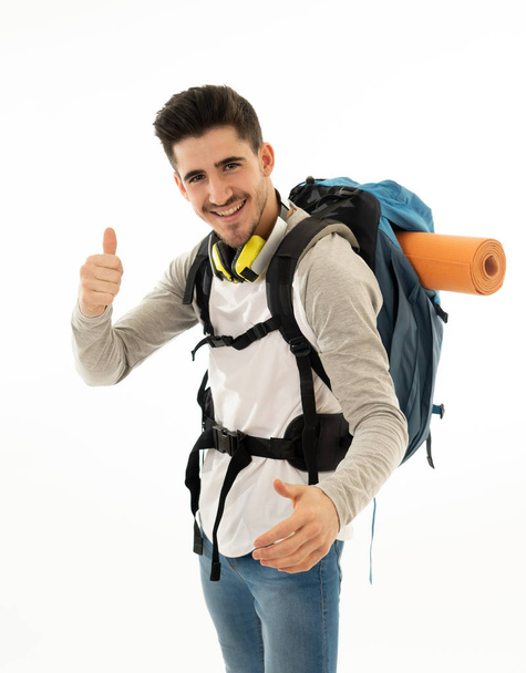 Portrait of happy cool latin man with backpack isolated on white background. In traveling the world, youth and living the dream, holidays student exchange and tourism and adventure vacation concept. - Photo, Image