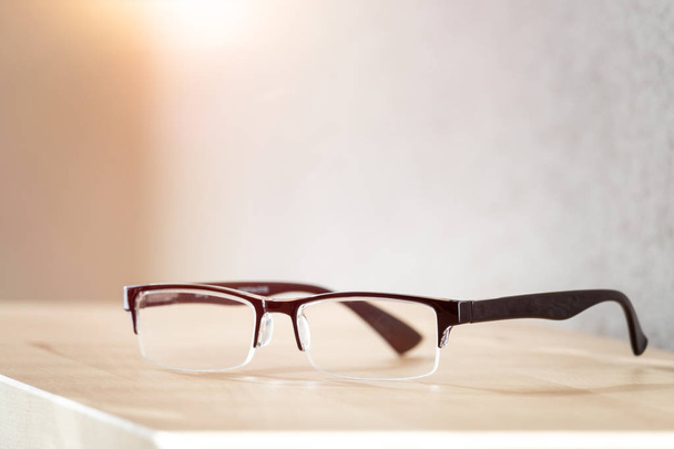 reading glasses on wooden table - Foto, Bild