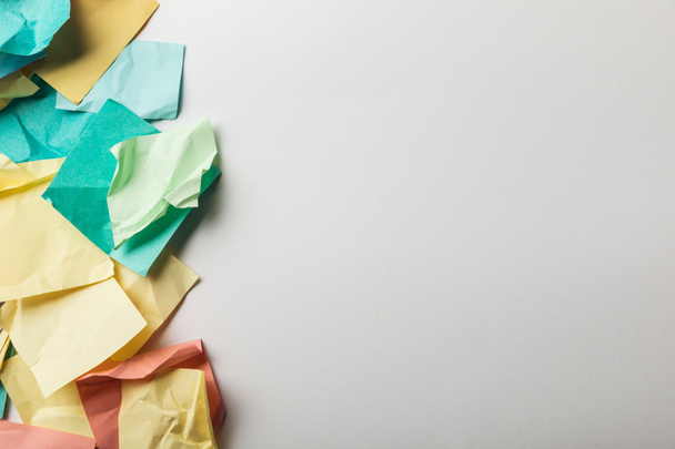 top view of crumpled colorful papers on white background - Fotografie, Obrázek