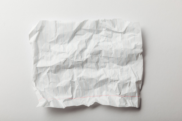 top view of white lined crumpled page on white background - Zdjęcie, obraz