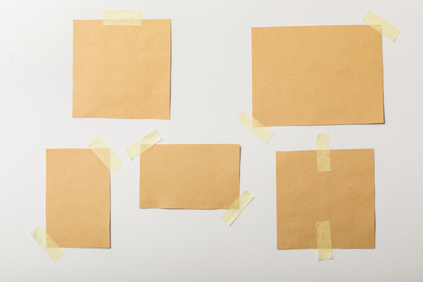 brown blank papers with sticky tape on white background - Photo, image