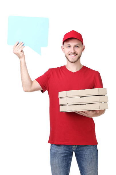 Delivery man with pizza and speech bubble on white background - Fotó, kép