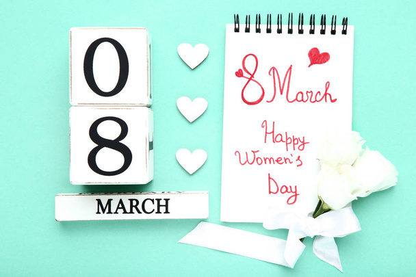 Wooden calendar with hearts and text Happy Women's Day in notepad - Photo, Image