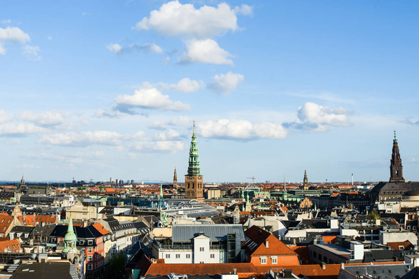 Aerial cityscape shot of old roofs, Nikolaj Kunsthal and Christiansborg Palace from the top of Rundetaarn Round Tower, famous Oresund Bridge between Sweden and Denmark on horizon, Copenhagen - Zdjęcie, obraz