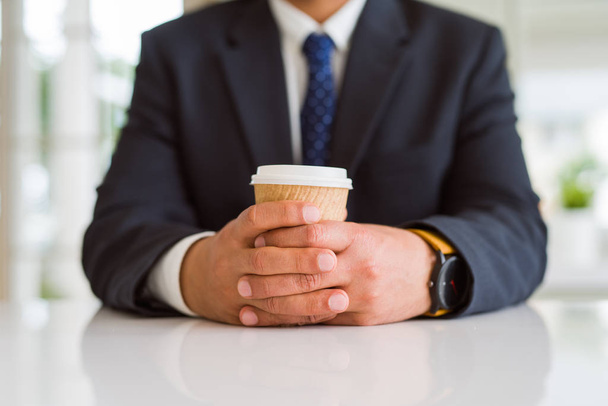 Close up of middle age man holding cup of coffee - Photo, image