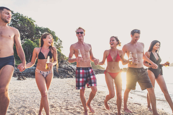 Group of friends having fun on the beach on a lonely island - Foto, Imagen