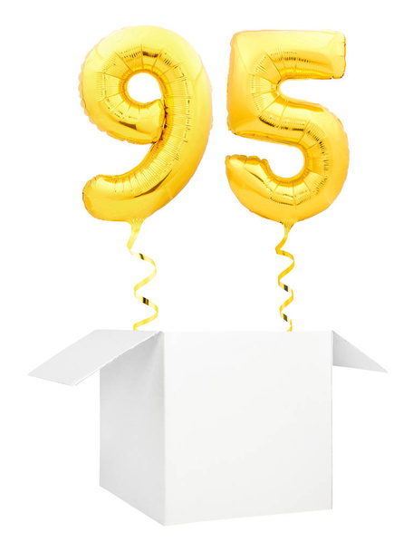 Golden number ninety five inflatable balloon with golden ribbon flying out of blank white box isolated on white background - Fotoğraf, Görsel