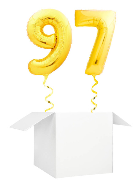 Golden number ninety seven inflatable balloon with golden ribbon flying out of blank white box isolated on white background - Fotoğraf, Görsel