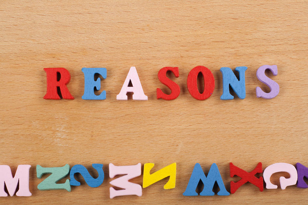 REASONS word on wooden background composed from colorful abc alphabet block wooden letters, copy space for ad text. Learning english concept - Φωτογραφία, εικόνα