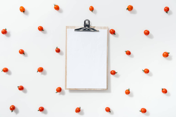 top view of blank clipboard with cherry tomatoes on white background  - Photo, Image