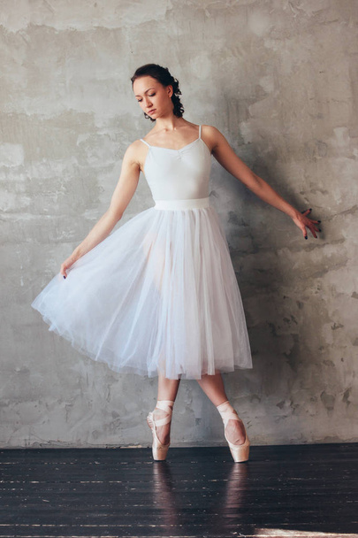 Ballet dancer ballerina in beautiful light blue dress tutu skirt posing in loft studio - Zdjęcie, obraz