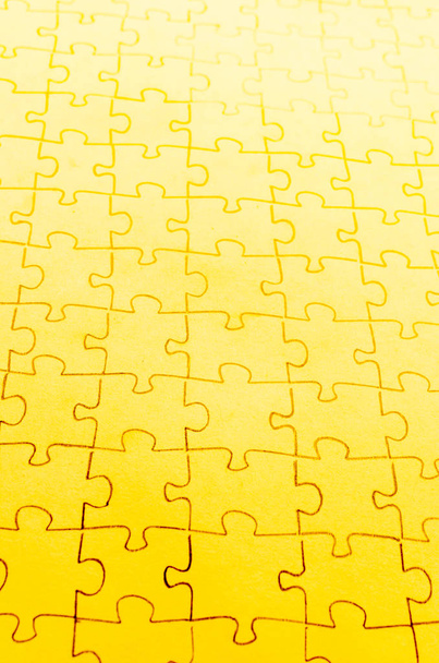Assembled puzzle on a bright yellow background. - 写真・画像