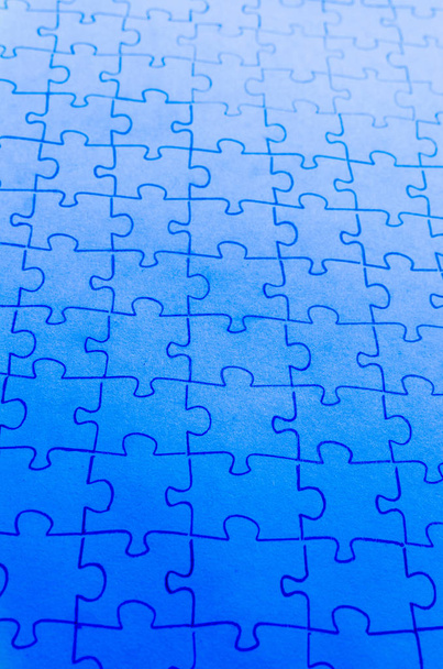 Assembled puzzle on a bright blue background. - Photo, image