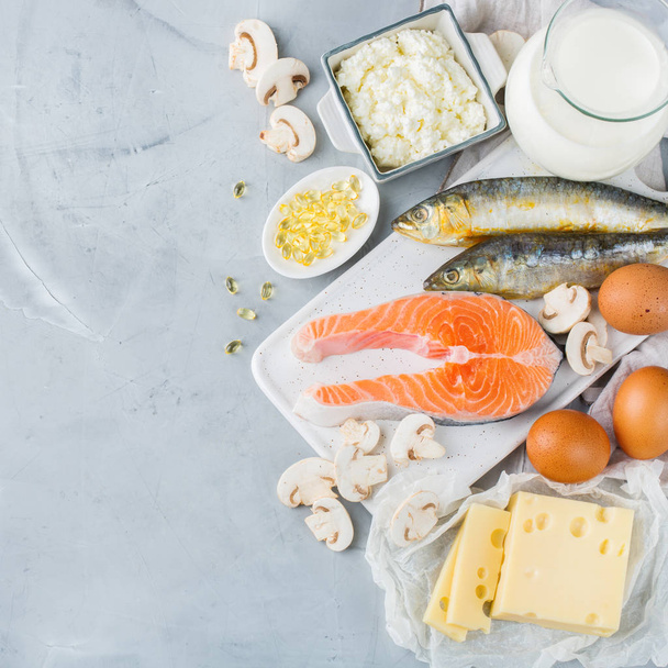 Nutrição dietética equilibrada, conceito de alimentação saudável. Sortimento de fontes de comida ricas em vitamina d, salmão, produtos de leite, leite, ovos, queijo, cogumelos, sardinhas em uma mesa de cozinha
 - Foto, Imagem
