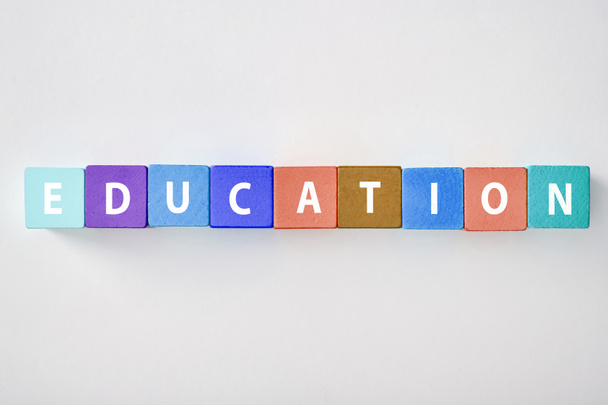 top view of education lettering made of multicolored blocks on grey background - Photo, Image