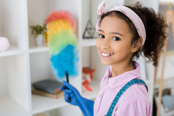 selective focus of african american child with multicolored duster - Foto, immagini